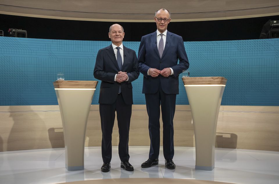 German Chancellor Olaf Scholz, left, and Friedrich Merz, CDU candidate for chancellor before a TV election debate in Berlin, (Michael Kappeler/DPA via AP)