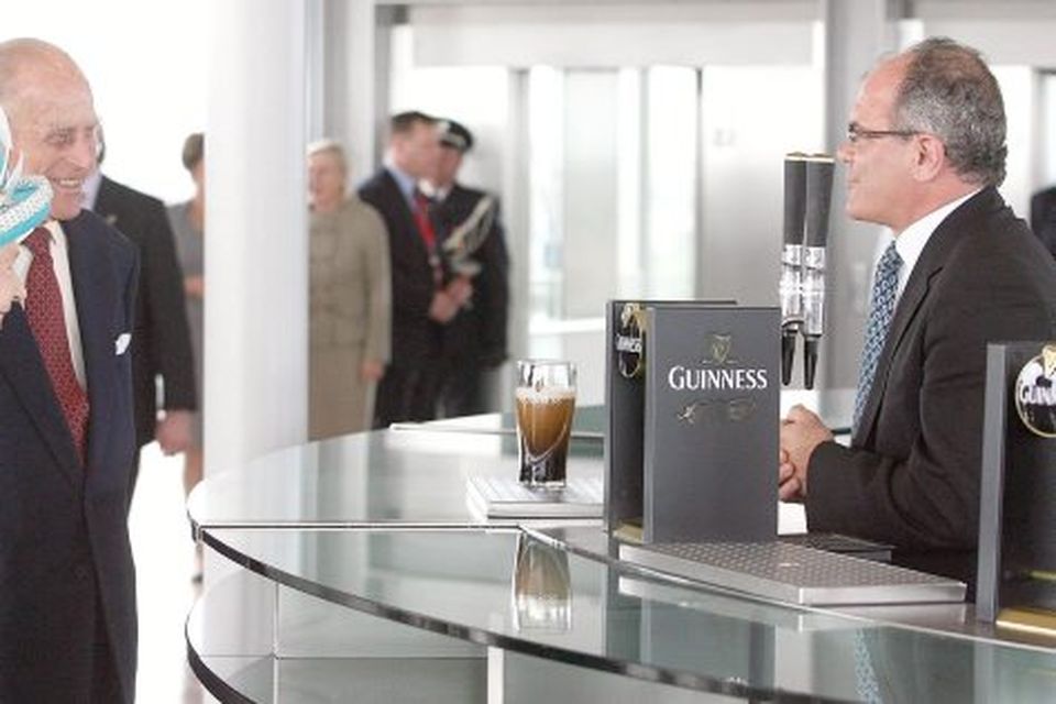Queen Elizabeth II and the Duke of Edinburgh offered a pint of Guinness  at the Guinness Storehouse