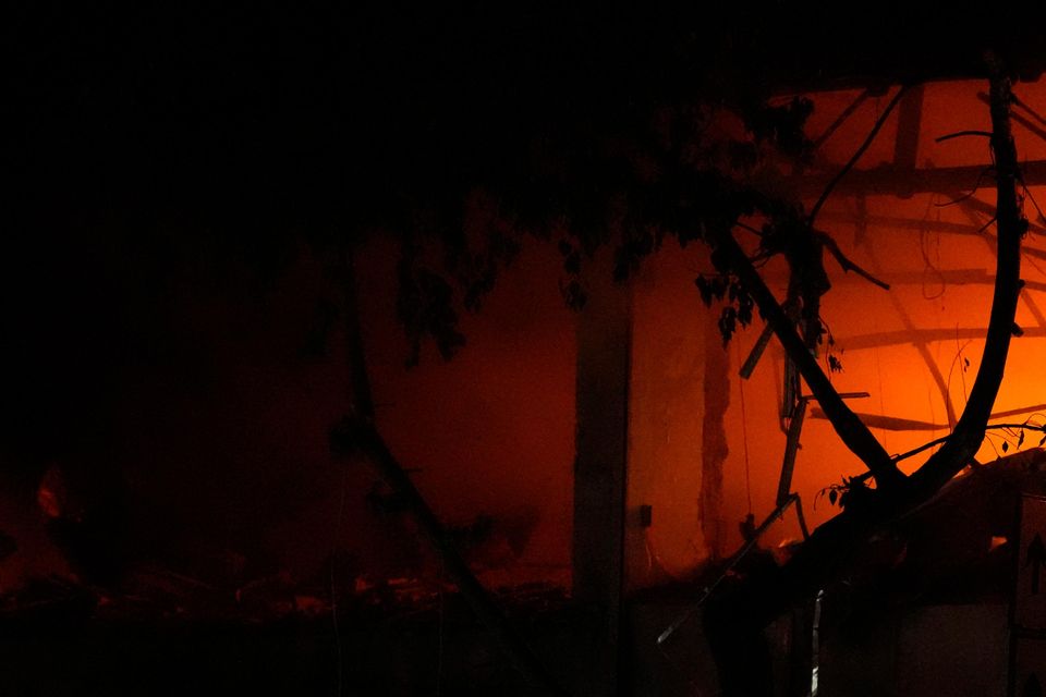 Civil defence workers extinguish a fire at the site of an Israeli airstrike in Beirut (Hassan Ammar/AP)