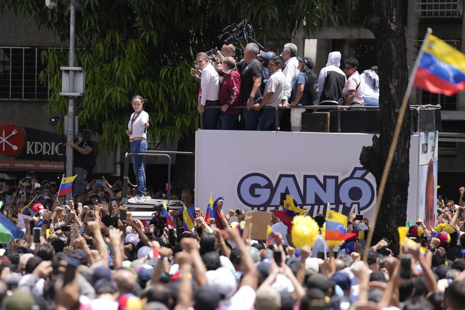 Supporters cheer for opposition leader Maria Corina Machado during a rally. (AP Photo/Matias Delacroix)