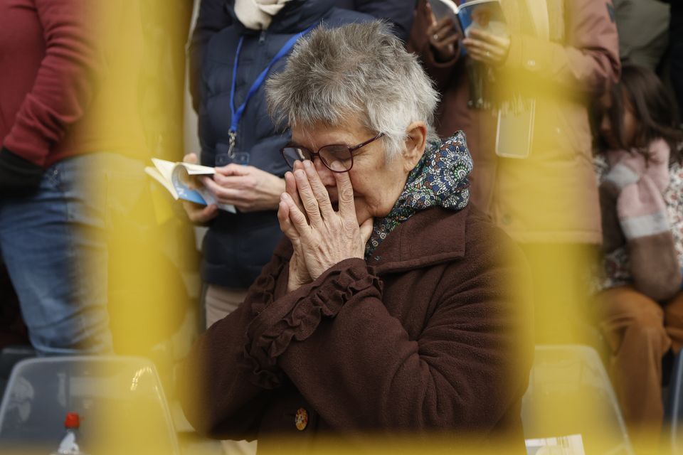 A woman prays as Francis addressed the crowd at mass on Sunday (Omar Havana/AP)