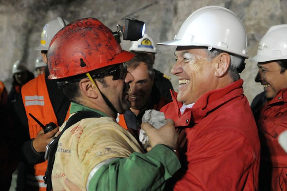 In this photo released by the Chilean presidential press office, Chile's President Sebastian Pinera, right, hugs rescued miner Mario Sepulveda after Sepulveda was rescued from the collapsed San Jose gold and copper mine where he was trapped with 32 other miners for over two months near Copiapo, Chile, early Wednesday Oct. 13, 2010.  (AP Photo/Jose Manuel de la Maza, Chilean presidential press office)