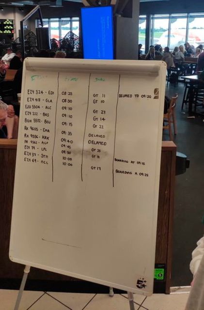 A whiteboard in Belfast International Airport today with flight information after the IT outage. Credit: Martin McElroy