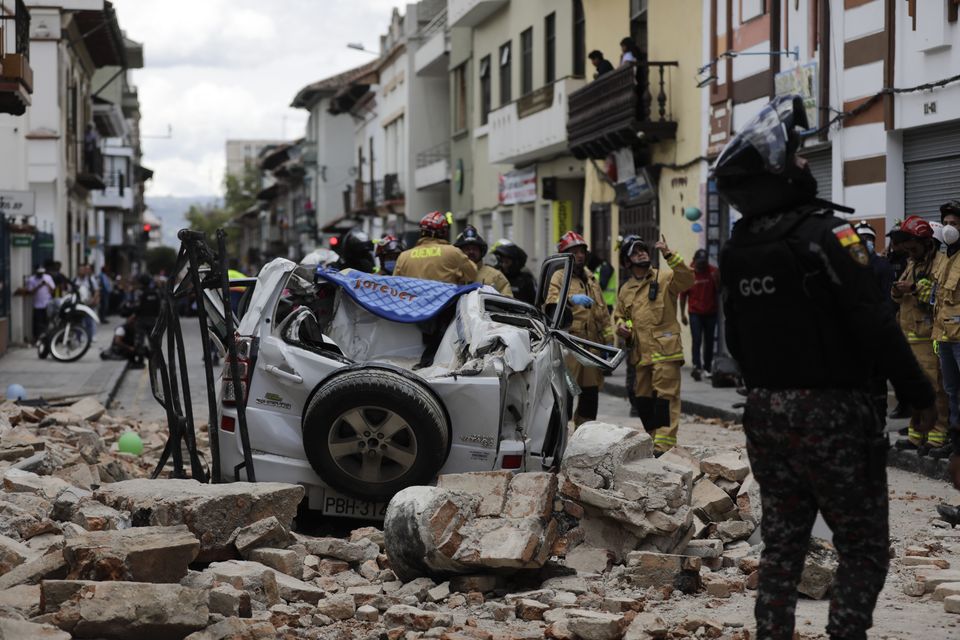 A car crushed by debris when the earthquake struck, in Cuenca, Ecuador (Xavier Caivinagua/AP)