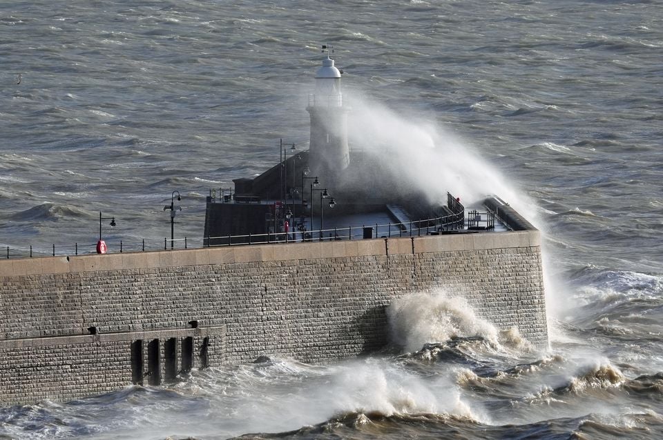 Waves crash over the harbour wall in Folkestone, Kent, on Monday (Gareth Fuller/PA)