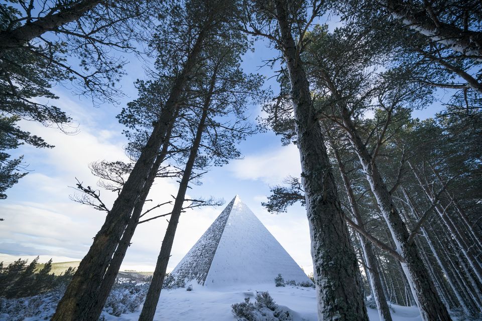 The Prince Albert Cairn, built in 1862 by Queen Victoria, rises out of the snow (Jane Barlow/PA)