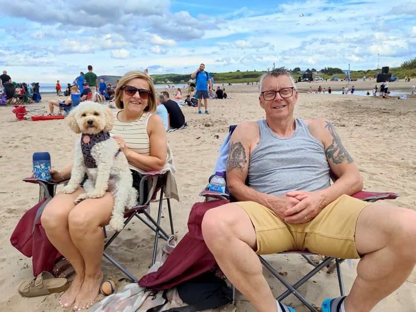 Nichola and Stephen McClenaghan with pup Lottie on the beach