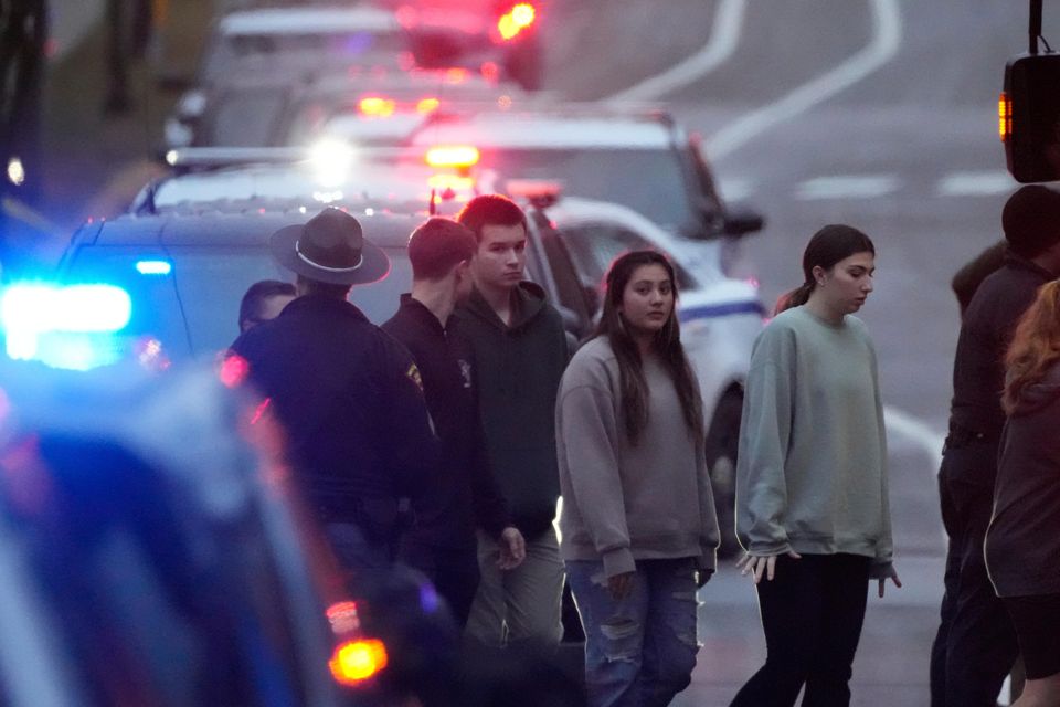 Students aboard a bus as they leave the shelter following a shooting at the Abundant Life Christian School (Morry Gash/AP)