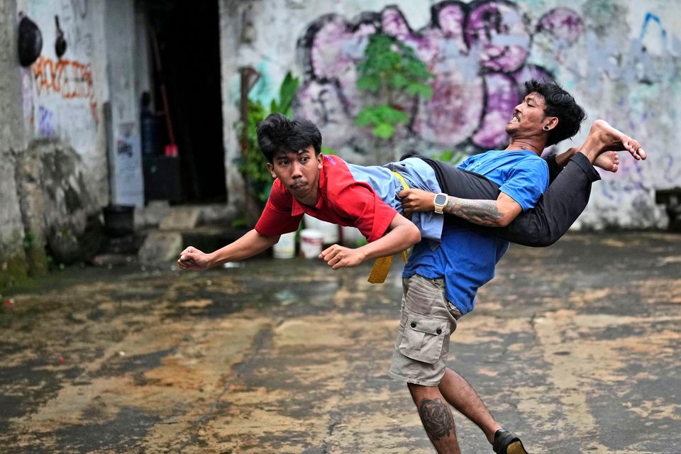 Dance club members Muhammad Hisyam, left, and Aji Permana, practise in Bogor (Dita Alangkara/AP)