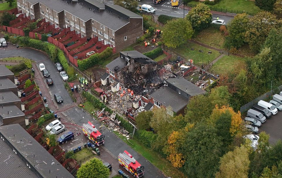 The house was still smouldering and the fire service had search dogs at the scene (Owen Humphreys/PA)