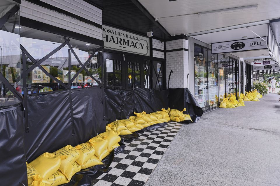 Sandbags and plastic sheets around shops in the Brisbane suburb of Rosalie, Australia (Jono Searle/AAP Image via AP)