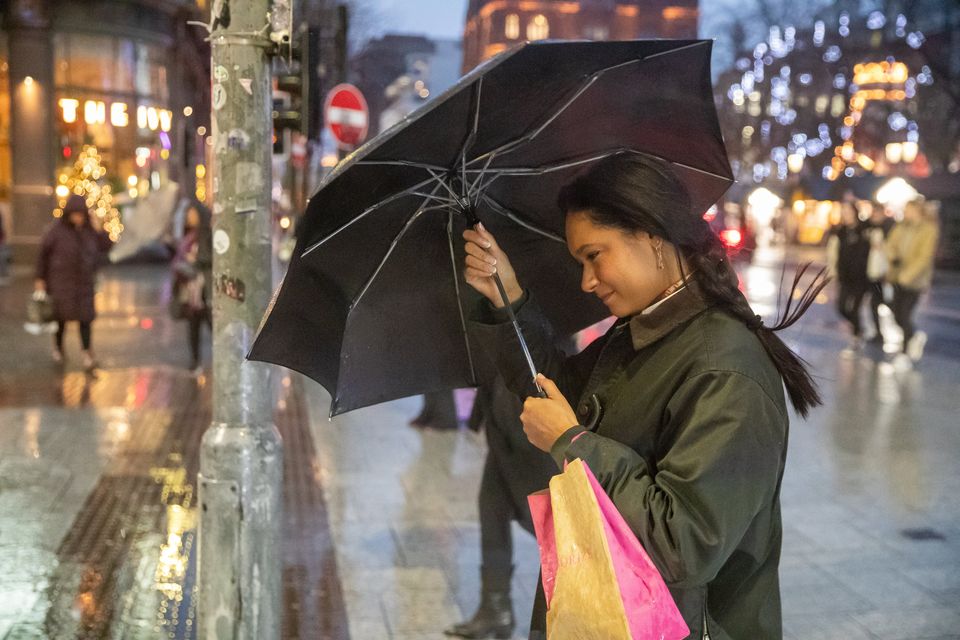 A shopper battling strong winds as Storm Darragh hit Belfast earlier this month (Photo by Luke Jervis / Belfast Telegraph)