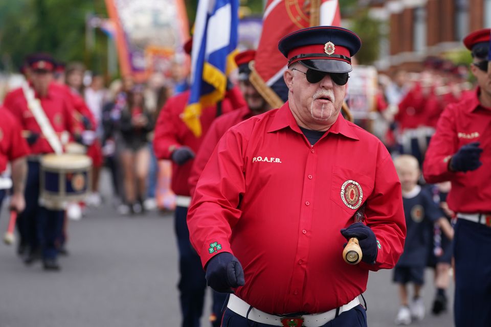 An Orange Order parade makes its way along the Crumlin Road on the morning of the Twelfth this year (Brian Lawless/PA)