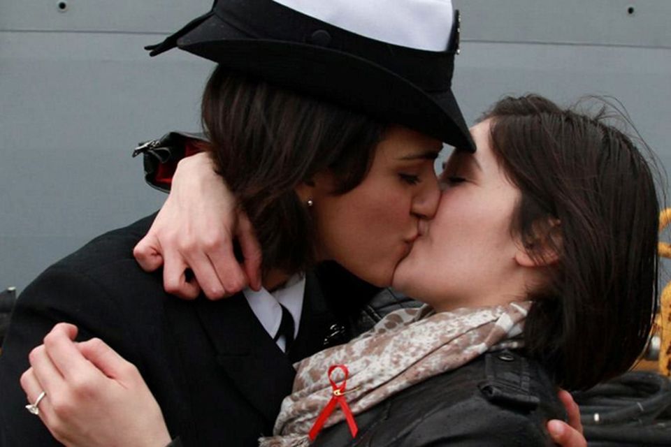 Traditional first kiss upon return of USS Oak Hill exchanged between two  lesbian sailors 