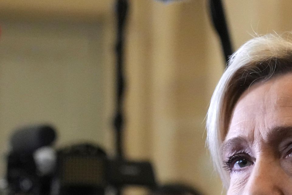 French far-right leader Marine Le Pen speaks to reporters at the National Assembly ahead of the vote (AP Photo/Michel Euler)