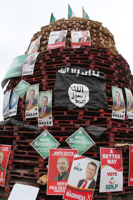 11th July Bonfires. Isis flag Ballysillan North Belfast. Pictures of Gerry Kelly, Alban Maginness