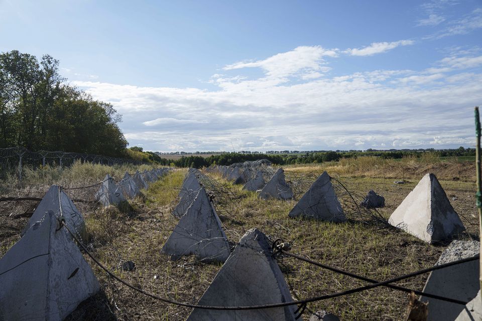 An anti-tank system known as ‘dragon teeth’ covers a field on the Russian-Ukrainian border (Evgeniy Maloletka/AP)