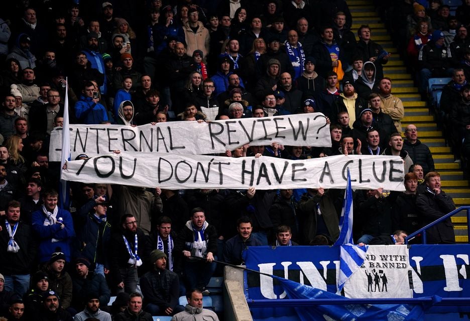 Leicester fans hold up a protest banner during the Premier League match against Arsenal (PA)