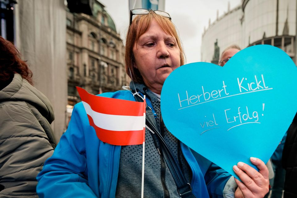 Astrid holds a heart shaped balloon with a good luck wish for Herbert Kickl, leader of the Freedom Party of Austria, during his final electoral campaign rally, held outside the St Stephen Cathedral, in Vienna (Andreea Alexandru/AP)