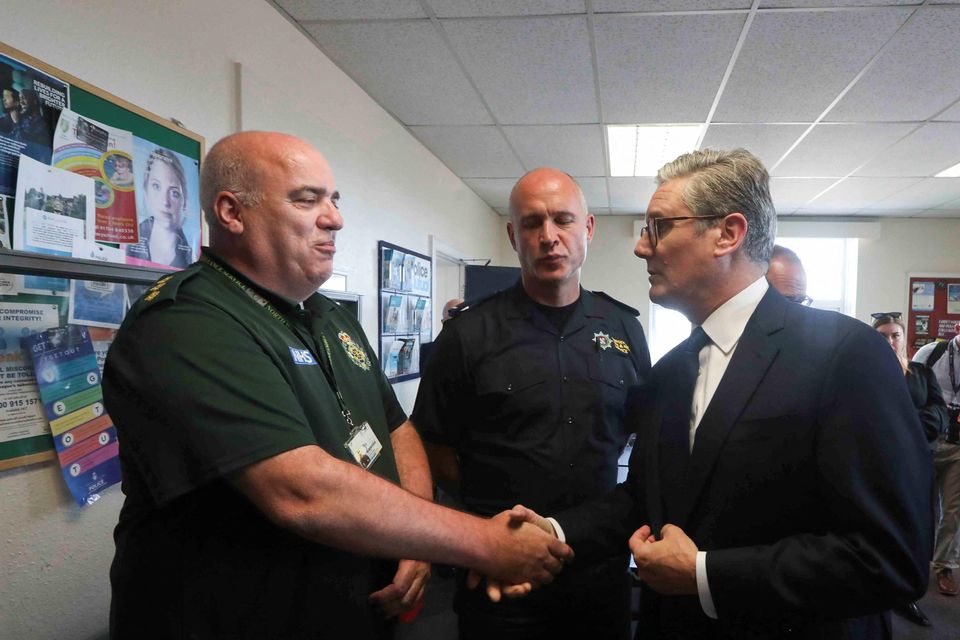 Prime Minister Sir Keir Starmer (right) meets with emergency personnel during a visit to Southport (Temilade Adelaja/PA)