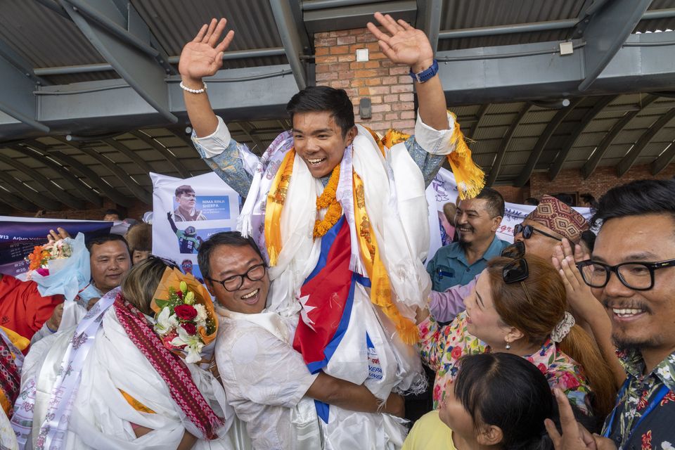 Minima Sherpa celebrates with his son,Nima Rinji Sherpa (AP)