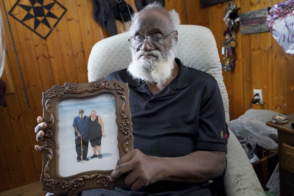 Kenny Pollard shows a holiday photo of himself with his wife Elizabeth (Matt Freed/AP)