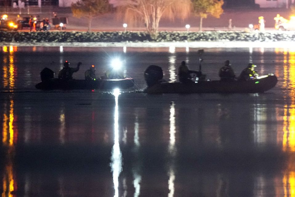 Boats work at the scene in the Potomac River near Ronald Reagan Washington National Airport (Alex Brandon/AP)