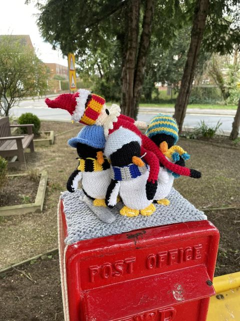 Pat the topper elf being ‘elfnapped’ by penguins (Brough Yarn Bombers/PA)