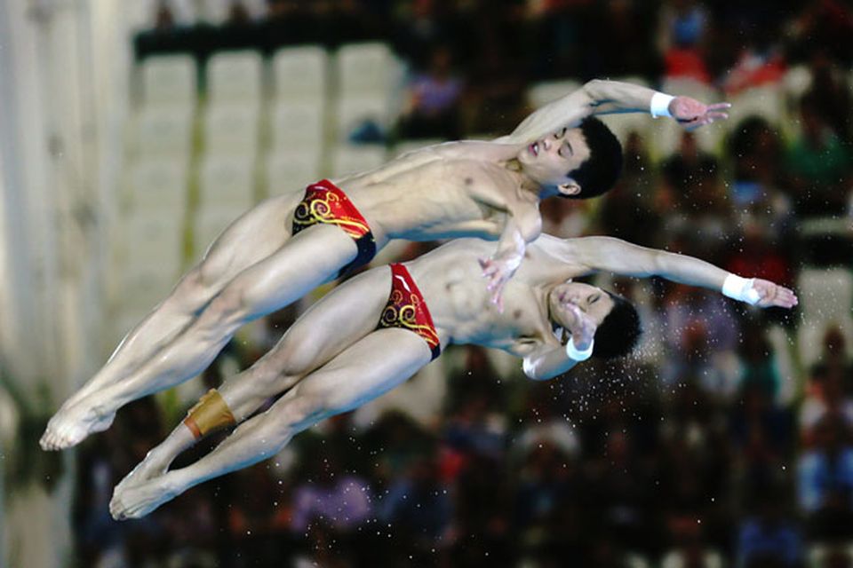 Yuan Cao and Yanquan Zhang of China compete in the Men's Synchronised 10m Platform Diving
