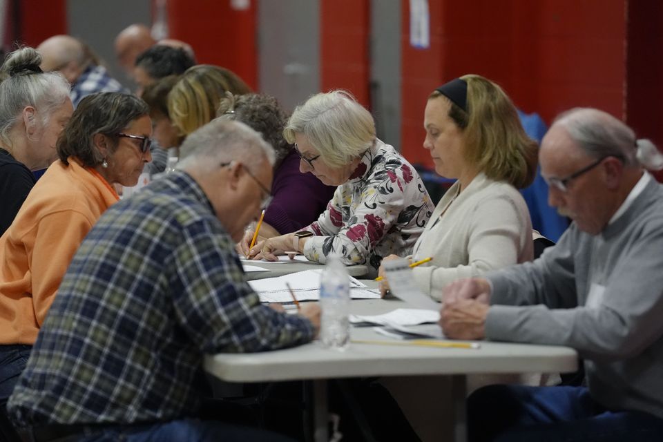 Poll workers count votes at a polling station in Derry, New Hampshire (Steven Senne/AP)