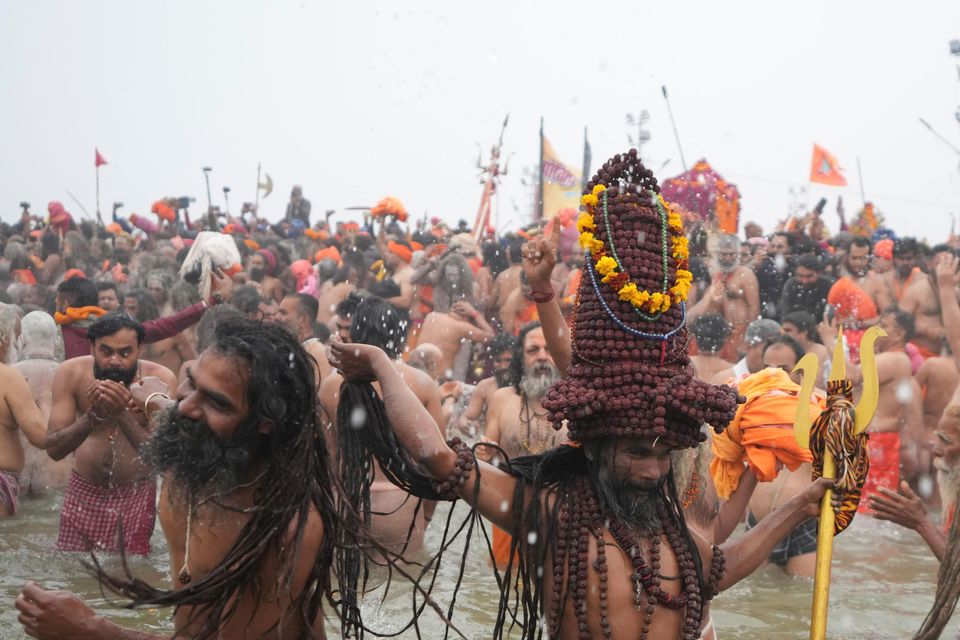 Naga Sadhus, or naked Hindu holy men, take dips on one of the most auspicious days of the Maha Kumbh festival (Rajesh Kumar Singh/AP)