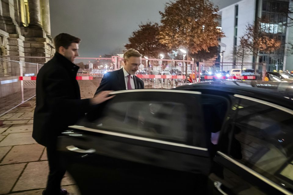 Germany’s minister of finance Christian Lindner, right, gets into his limousine in front of the Reichstag building after his dismissal (Christoph Soeder/AP)