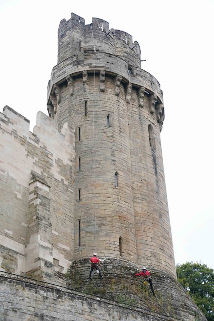 The specialist restorers carefully make their way down the tower (Jacob King/PA)