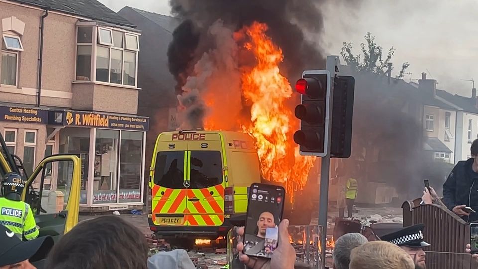 A police van was set alight as trouble flared during the far-right protest on Tuesday (Richard McCarthy/PA)