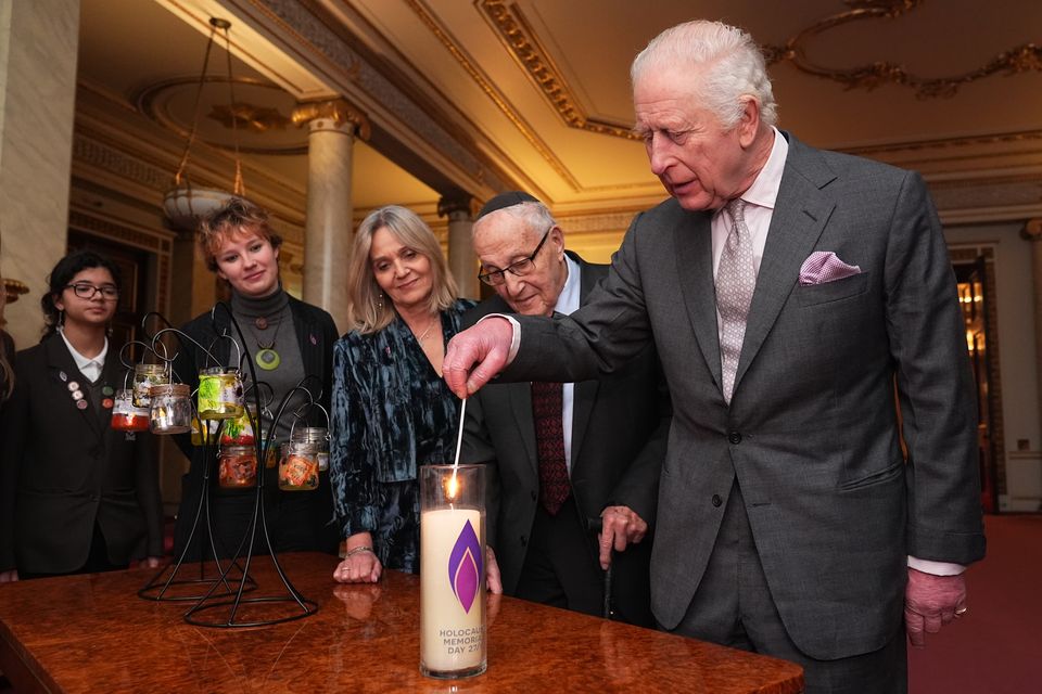 King Charles III lights a candle during a reception marking Holocaust Memorial Day, when he said that the upcoming visit to Auschwitz-Birkenau as ‘so important’ (Aaron Chown/PA)