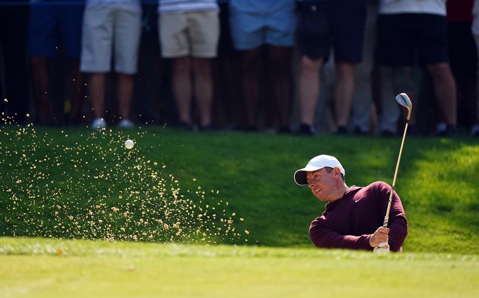 Rory McIlroy plays out of a bunker on the 15th on day one of the BMW PGA Championship at Wentworth (Zac Goodwin/PA)