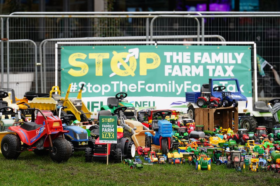 Members of the National Farming Union’s Stop the Family Farm Tax campaign place pre-loved farming toys outside the QEII Centre in London during a protest in February (Jordan Pettitt/PA)