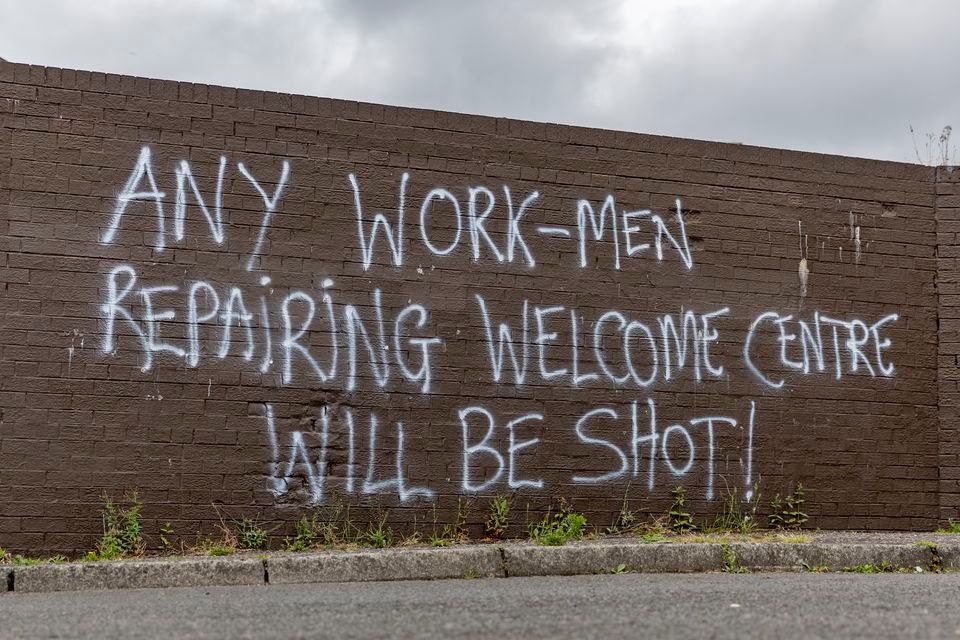 Graffiti threatening people working on repairing the centre. Pic: Kevin Scott