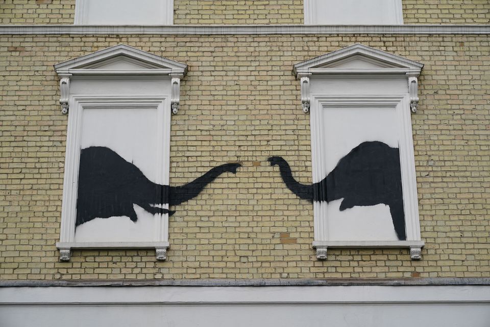 A Banksy artwork depicting two elephants poking their heads out of blocked out windows was unveiled on the side of a building in Chelsea on Tuesday (Yui Mok/PA)