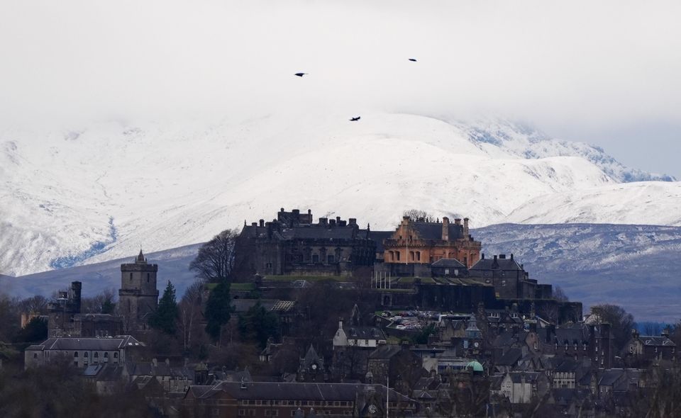 Snow covered the mountains behind Stirling Castle, Stirling, Scotland, on Saturday (Andrew Milligan/PA)