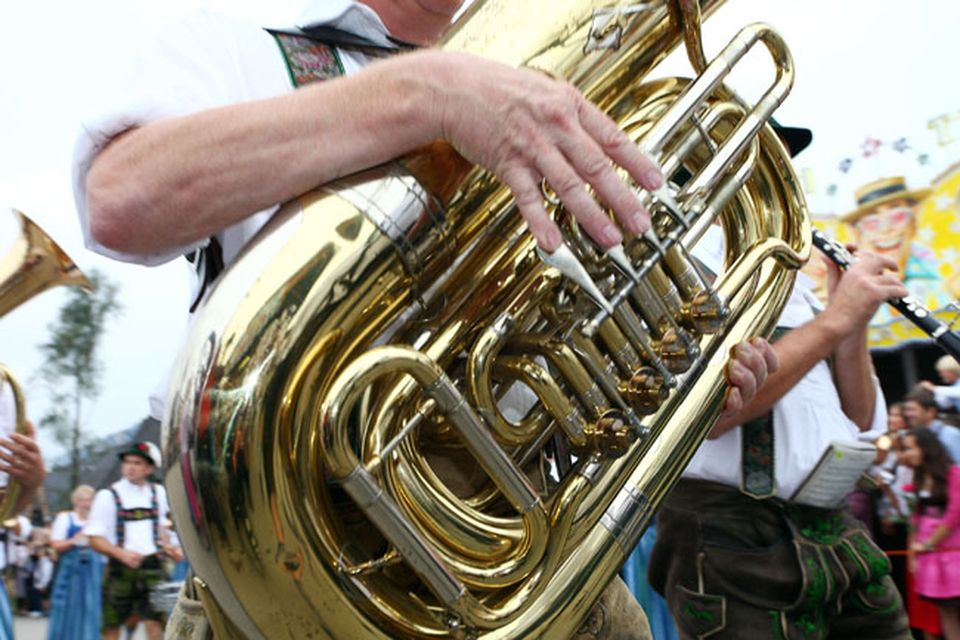 Man playing the tuba in traditional Tyrolean costume, Hamburg]