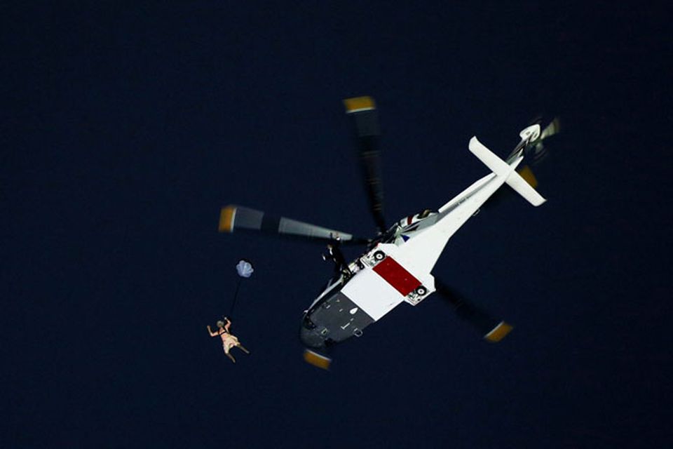 LONDON, ENGLAND - JULY 27:  Gary Connery and Mark Sutton parachute into the stadium as part of short James Bond film featuring Daniel Craig and The Queen during the Opening Ceremony of the London 2012 Olympic Games at the Olympic Stadium on July 27, 2012 in London, England.  (Photo by Cameron Spencer/Getty Images)