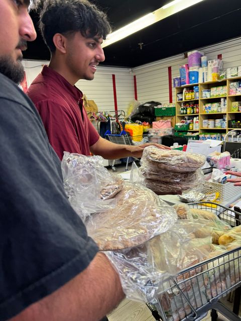 Omar Ahmad (left) and Zaki Ahmedi (right) delivering roti breads to a food bank in Bordon, East Hampshire (Sabah Ahmedi/PA)