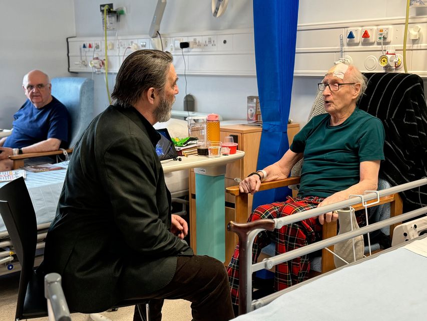 Oscar-nominated actor Ciaran Hinds with speaking patients at Whiteabbey Hospital