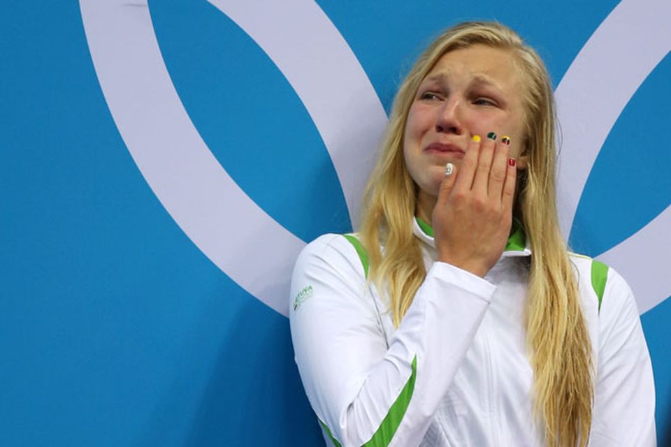 LONDON, ENGLAND - JULY 30:  Ruta Meilutyte of Lithuania reacts as she receives her gold medal during the medal ceremony for the Women's 100m Breaststroke on Day 3 of the London 2012 Olympic Games at the Aquatics Centre on July 30, 2012 in London, England.  (Photo by Clive Rose/Getty Images)