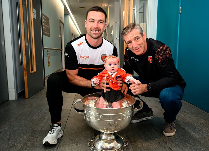 Four-month-old Faé McKee, from Portadown, with Armagh captain Aidan Forker, and manager Kieran McGeeney, and the Sam Maguire cup during the All-Ireland Football Champions visit to the Craigavon Area Hospital in Portadown, Armagh. Photo by Ramsey Cardy/Sportsfile