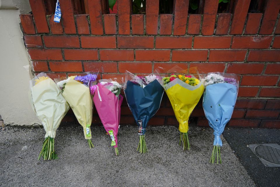 Flowers laid near a house in Blackpool after a man and a woman died (Peter Byrne/PA)