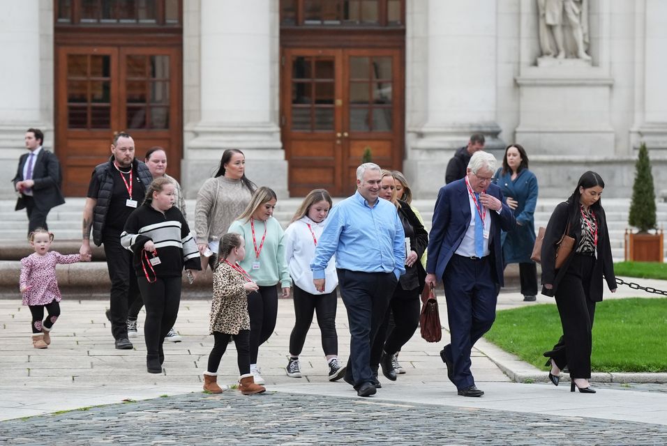 Solicitor Damien Tansey with affected families outside Government Buildings, Dublin (Niall Carson/PA)