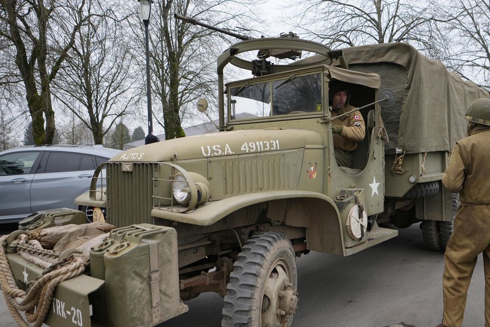 Living history enthusiasts drive their vintage vehicles during the 80th commemoration of the Battle of the Bulge in Bastogne, Belgium (Virginia Mayo/AP)