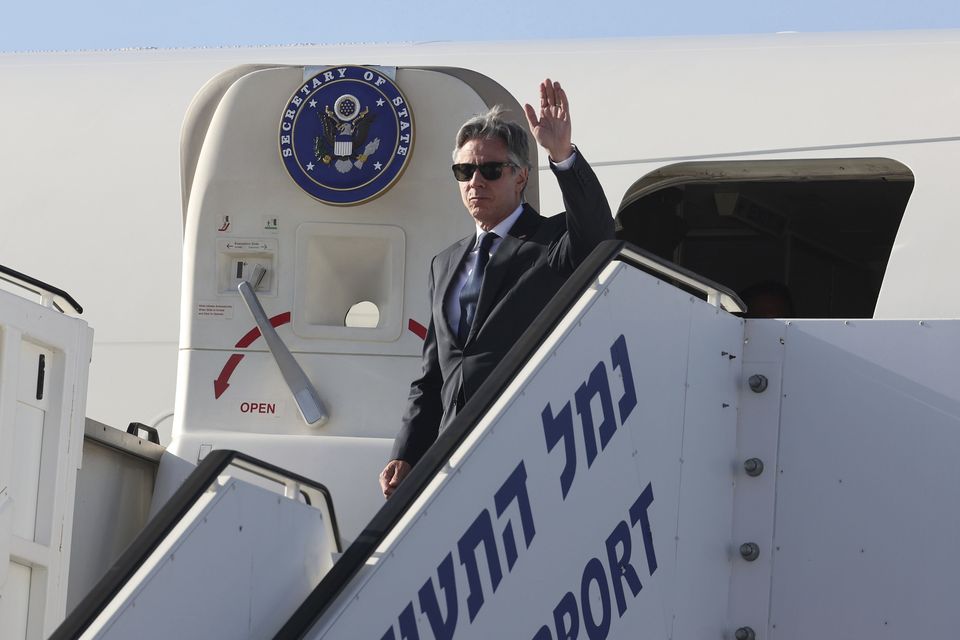 Antony Blinken waves as he arrives at Ben Gurion airport near Tel Aviv (Jack Guez/Pool via AP)